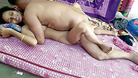 Indian brunette in a colorful outfit gets naked in bedroom