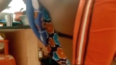 Indian brunette in a black dress is having sex on the kitchen table