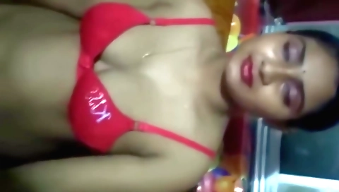 Brunette in black dress and stockings in a bedroom