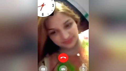 Redheaded lady in a white blouse enjoys a solo sex video